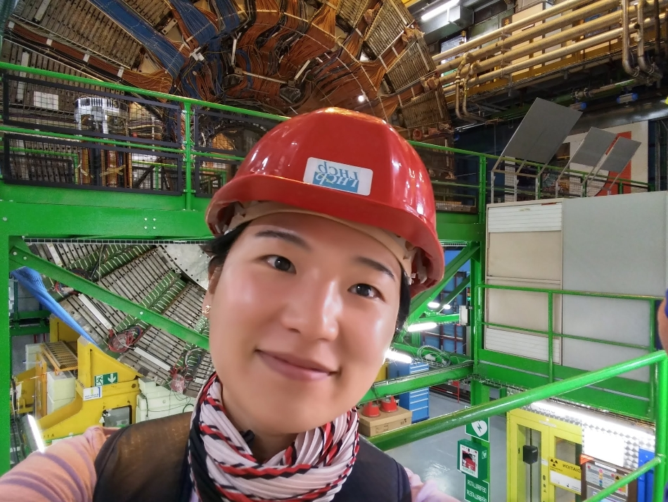 Dr Jihyun Bhom from the Institute of Nuclear Physics of the Polish Academy of Sciences in Cracow against the background of the LHCb detector at CERN.