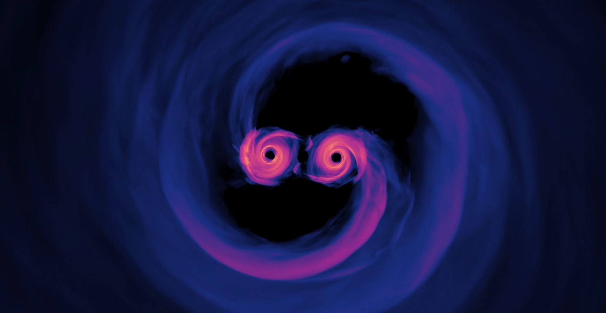 The gravitational waves emitted by the merger of black holes, when lensed by massive objects as the waves travel toward Earth can be used to calculate the rate at which the universe is expanding.