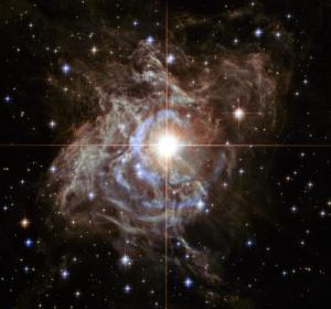 Hubble Portrays Bright Southern Hemisphere Star Swaddled in a Gossamer Cocoon of Reflective Dust